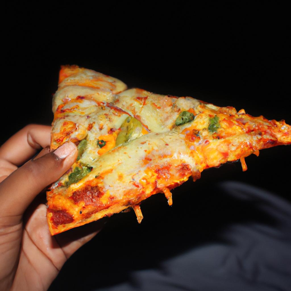Person Holding A Pizza Slice